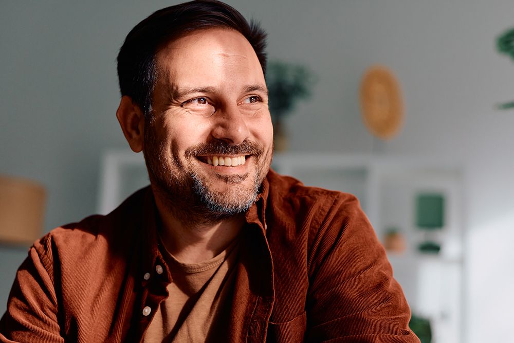 Man looking out the window happy after Ketamine treatment